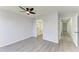 Bedroom with ceiling fan, wood-look floors, and en-suite bathroom at 5541 Rosehill Rd # 201, Sarasota, FL 34233