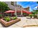 Outdoor cafe with red umbrellas and brick planters at 5541 Rosehill Rd # 201, Sarasota, FL 34233