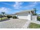 Home exterior with paved driveway and landscaped yard at 5838 Tyler Rd, Venice, FL 34293