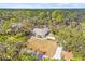Single-story home surrounded by lush trees on a large lot at 610 Woodview Way, Bradenton, FL 34212