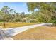 Property's aerial view showing house, driveway, and surrounding landscape at 610 Woodview Way, Bradenton, FL 34212