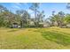 Large grassy backyard with mature trees at 610 Woodview Way, Bradenton, FL 34212