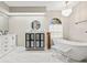 Elegant bathroom featuring a soaking tub, double vanity, and marble floors at 610 Woodview Way, Bradenton, FL 34212