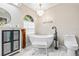 Bathroom with a free-standing bathtub, double vanity, and marble floors at 610 Woodview Way, Bradenton, FL 34212