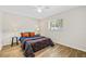 Cozy bedroom with floral bedding and wood-look floors at 610 Woodview Way, Bradenton, FL 34212