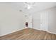 Spacious bedroom with wood-look floors and access to another room at 610 Woodview Way, Bradenton, FL 34212