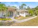 House exterior showcasing landscaping, walkway, and architectural details at 610 Woodview Way, Bradenton, FL 34212