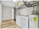 Bright laundry room with washer, dryer, and utility sink at 610 Woodview Way, Bradenton, FL 34212