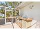 Outdoor kitchen with grill and sink at 610 Woodview Way, Bradenton, FL 34212