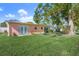 Large backyard with a peach-colored house and lush grass at 6213 Green View Dr # 127, Sarasota, FL 34231