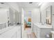 Bathroom with double vanity and view into bedroom at 6213 Green View Dr # 127, Sarasota, FL 34231