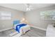 Bright bedroom with light gray walls, blue bedspread, and vinyl wood flooring at 6213 Green View Dr # 127, Sarasota, FL 34231