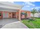 View of the home's exterior, carport, and landscaping at 6213 Green View Dr # 127, Sarasota, FL 34231