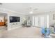 Spacious living room with large TV and access to patio at 6213 Green View Dr # 127, Sarasota, FL 34231