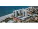 Aerial view of beachfront buildings, parking, and landscaping at 627 Alhambra Rd # 601, Venice, FL 34285