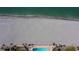 Aerial view of beach, pool, and surrounding landscape at 627 Alhambra Rd # 601, Venice, FL 34285