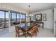 Bright dining room with glass-top table and balcony access at 627 Alhambra Rd # 601, Venice, FL 34285