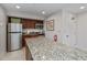 Well-equipped condo kitchen with granite countertops at 627 Alhambra Rd # 601, Venice, FL 34285