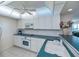Modern kitchen with white cabinets, teal countertops, and a ceiling fan at 627 Alhambra Rd # 601, Venice, FL 34285