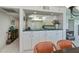 Bright kitchen features white cabinets, teal countertops, and modern appliances at 627 Alhambra Rd # 601, Venice, FL 34285