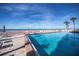 Expansive heated pool with lounge chairs and beach access at 627 Alhambra Rd # 601, Venice, FL 34285
