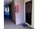 Condo hallway with doors and fire extinguisher at 634 Bird Bay E Dr # 103, Venice, FL 34285