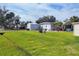 Spacious backyard with grassy area and storage shed at 6401 Floral Ct, North Port, FL 34287
