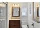 Bathroom with wood vanity, toilet, and shower/tub combo at 6401 Floral Ct, North Port, FL 34287
