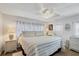 Bright bedroom with a king-size bed and white wicker nightstands at 6401 Floral Ct, North Port, FL 34287