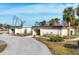 Tan colored community building with landscaping and parking at 6401 Floral Ct, North Port, FL 34287