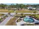 Landscaped circular fountain with palm trees and walkways, creating a relaxing atmosphere at 6401 Floral Ct, North Port, FL 34287