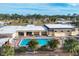 Aerial view of community pool with surrounding lounge chairs and palm trees at 6401 Floral Ct, North Port, FL 34287