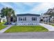 Mobile home exterior with landscaping and covered carport at 6401 Floral Ct, North Port, FL 34287