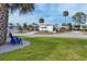 Mobile home exterior with landscaping and blue chairs at 6401 Floral Ct, North Port, FL 34287