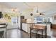 Kitchen boasts white cabinets, stainless steel appliances and a breakfast bar at 6401 Floral Ct, North Port, FL 34287