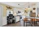 Kitchen with white cabinets, stainless steel appliances, and breakfast nook at 6401 Floral Ct, North Port, FL 34287