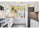 Kitchen with white cabinets, stainless steel appliances, and a breakfast bar at 6401 Floral Ct, North Port, FL 34287