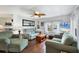 Living room with two sofas, coffee table, and a view of the kitchen at 6401 Floral Ct, North Port, FL 34287