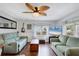 Living room with two sofas, coffee table, and wood floors at 6401 Floral Ct, North Port, FL 34287