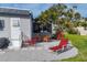 Relaxing patio area with lounge chairs and a beautiful tree at 6401 Floral Ct, North Port, FL 34287