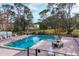 Relaxing community pool with surrounding lounge chairs at 6401 Floral Ct, North Port, FL 34287
