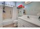 Bathroom with tub, shower, white vanity, and updated flooring at 647 White Pine Tree Rd # 34, Venice, FL 34285