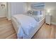 Bedroom with a queen-size bed and light wood flooring at 647 White Pine Tree Rd # 34, Venice, FL 34285