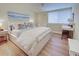 Bright bedroom with a comfy bed, wood floors and workspace at 647 White Pine Tree Rd # 34, Venice, FL 34285