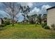 Landscaped community grounds with mature trees and pond at 647 White Pine Tree Rd # 34, Venice, FL 34285