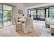 Bright dining area with white table and chairs, overlooking a balcony at 647 White Pine Tree Rd # 34, Venice, FL 34285
