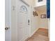 Bright entryway with white door and wood-look flooring at 647 White Pine Tree Rd # 34, Venice, FL 34285