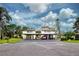 Two-story condo building with carport and lush landscaping at 647 White Pine Tree Rd # 34, Venice, FL 34285