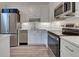 Modern kitchen featuring stainless steel appliances and white cabinets at 647 White Pine Tree Rd # 34, Venice, FL 34285