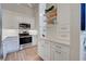 Modern kitchen with white cabinets and stainless steel appliances at 647 White Pine Tree Rd # 34, Venice, FL 34285